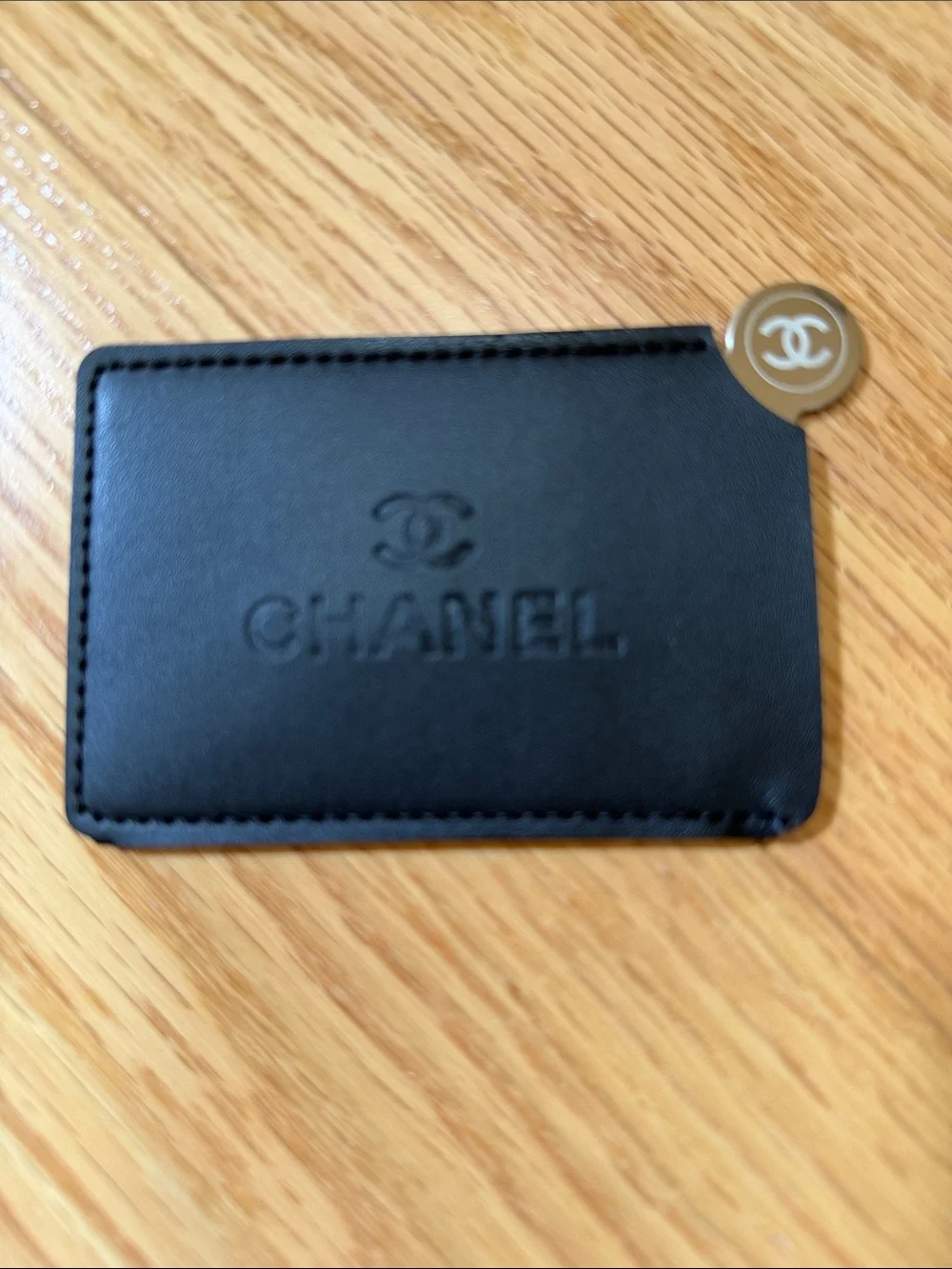 Chanel black card case with mirror.
